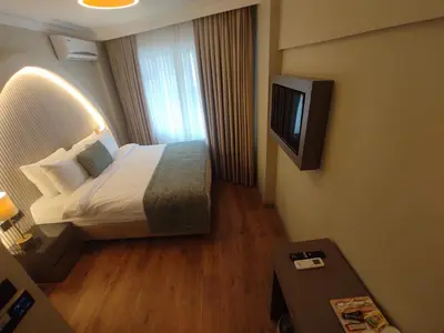 a hotel room with a bed and a television at Mara Oldcity Hotel in Istanbul