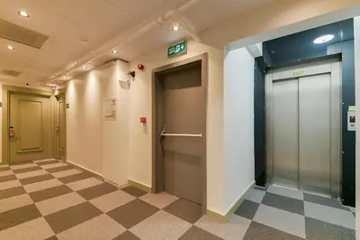 a hallway with two doors and a checkered floor at Rise Inn in Istanbul