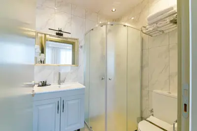 a bathroom with a shower and a sink and a toilet at Rise Inn in Istanbul