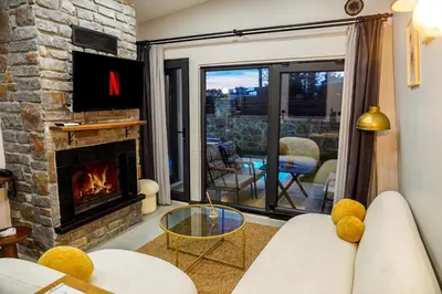 a living room with a couch and a fireplace at Vital Home Sapanca Isıtmalı Havuzlu Villa&Bungalov in Sapanca
