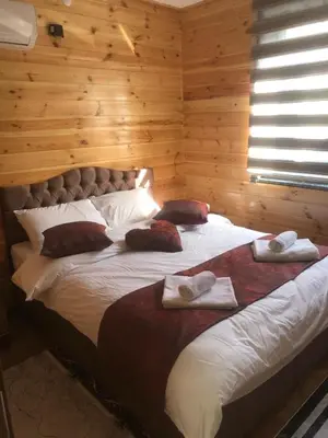 a bedroom with a large bed with towels on it at SAPANCA FAMİLY RESORT in Kartepe