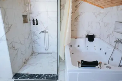 a white bathroom with a tub and a shower at SAPANCA FAMİLY RESORT in Kartepe