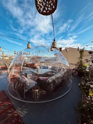 a glass dome with couches and chairs on a patio at Waterfront Villa by the Tram - Private Terrace with Dome & Golden Horn View in Fatih in Istanbul