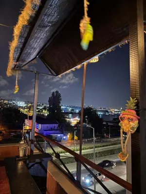 a bar with a view of a city at night at Waterfront Villa by the Tram - Private Terrace with Dome & Golden Horn View in Fatih in Istanbul