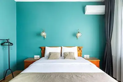 a blue bedroom with a large bed with two night stands at Waterfront Villa by the Tram - Private Terrace with Dome & Golden Horn View in Fatih in Istanbul
