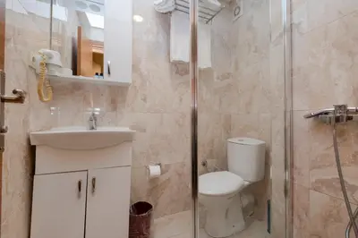 a bathroom with a toilet and a sink and a shower at Sisli MLS Hotel in Istanbul