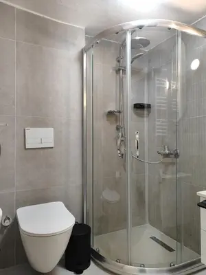 a bathroom with a glass shower with a toilet at Flex Ortakoy in Istanbul