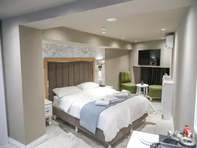 a bedroom with a large bed with towels on it at La Vida Ex Palazzo Suit Karaköy in Istanbul