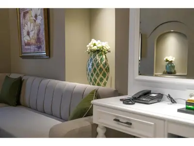 a living room with a couch and a vase with flowers at La Vida Ex Palazzo Suit Karaköy in Istanbul