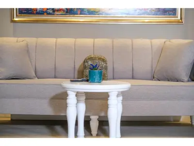 a table in front of a couch with a chair at La Vida Ex Palazzo Suit Karaköy in Istanbul