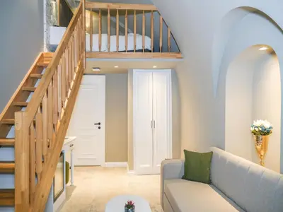 a living room with a staircase and a couch at La Vida Ex Palazzo Suit Karaköy in Istanbul