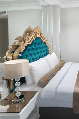 a bedroom with a white bed with a blue headboard at White Monarch Hotel in Istanbul