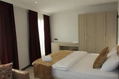a bedroom with a bed with white sheets and a window at Eyüp Sultan Palace Hotel in Istanbul