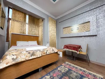a bedroom with a bed and a chair and a rug at The New Season Apart in Istanbul