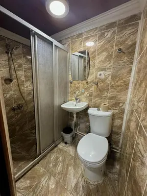 a bathroom with a toilet and a sink and a shower at The New Season Apart in Istanbul