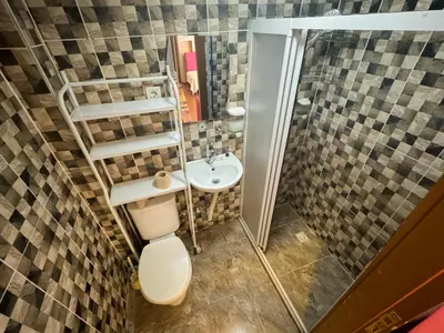 a small bathroom with a toilet and a sink at The New Season Apart in Istanbul