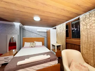 a bedroom with a bed and a desk and a chair at The New Season Apart in Istanbul