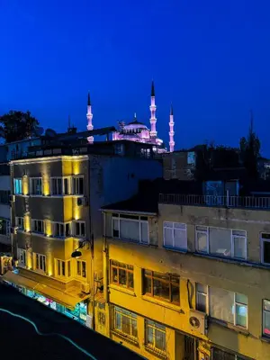a building with a mosque in the background at night at The New Season Apart in Istanbul