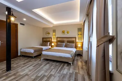 a hotel room with two beds and a hallway at LINNGA HOTEL & SUITE in Istanbul