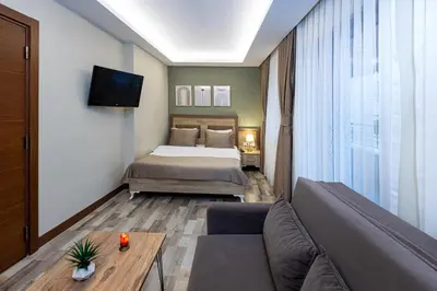 a hotel room with a bed and a couch at LINNGA HOTEL & SUITE in Istanbul