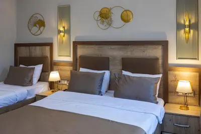 a bedroom with two beds and two lamps and lights at LINNGA HOTEL & SUITE in Istanbul