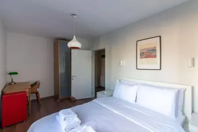 a bedroom with a white bed and a desk at Bright Loft with 3 bedrooms and terrace in Galata in Istanbul