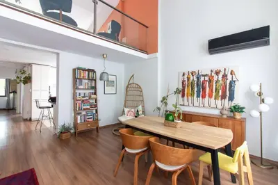a living room with a wooden table and chairs at Bright Loft with 3 bedrooms and terrace in Galata in Istanbul