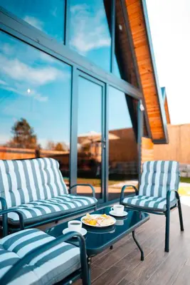 a patio with two chairs and a table with a plate of food at MY RESORT PRİVE in Sapanca
