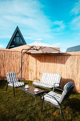 two chairs and a table with an umbrella at MY RESORT PRİVE in Sapanca