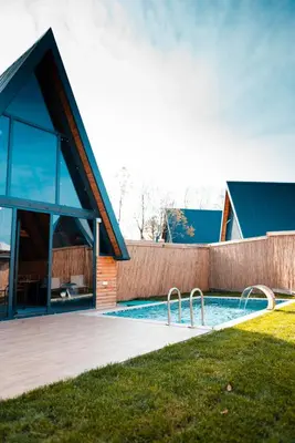 a house with a swimming pool next to a building at MY RESORT PRİVE in Sapanca