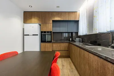 a kitchen with a long wooden table and red chairs at Brand New Duplex wParking 2BD2Bath Home #336 in Istanbul