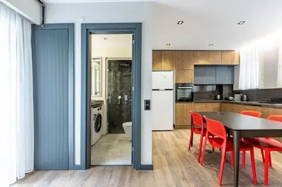 a kitchen and dining room with a table and red chairs at Brand New Duplex wParking 2BD2Bath Home #336 in Istanbul