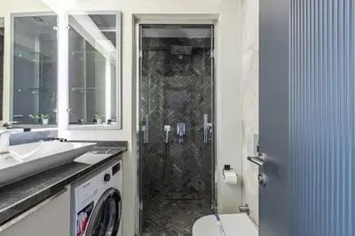 a bathroom with a shower with a toilet and a sink at Brand New Duplex wParking 2BD2Bath Home #336 in Istanbul
