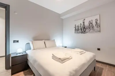 a bedroom with a bed with two towels on it at Brand New Duplex wParking 2BD2Bath Home #336 in Istanbul