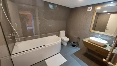 a bathroom with a tub and a toilet and a sink at Patya BUNGALOV in Dereköy