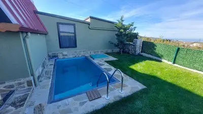 a swimming pool in the yard of a house at Patya BUNGALOV in Dereköy