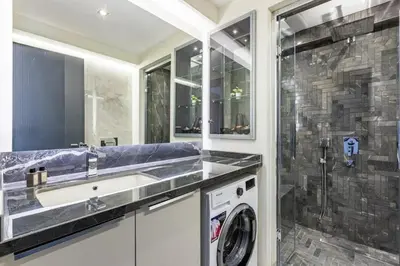 a bathroom with a sink and a washing machine at Cozy Bright wParking 2BD1Bath Central Home!#338 in Istanbul