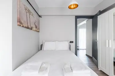 a white bedroom with a large bed in it at Charming Bright New 2BD1Bath Home wparking!#339 in Istanbul