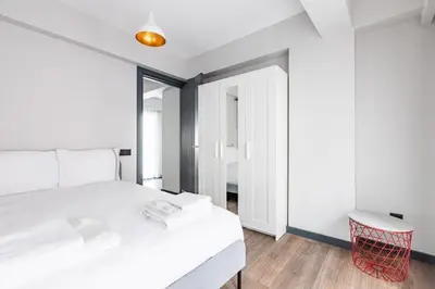 a bedroom with a white bed and a red stool at Charming Bright New 2BD1Bath Home wparking!#339 in Istanbul