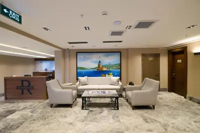 a lobby with couches and a table in a building at B'İSTANBUL HOTEL in Istanbul