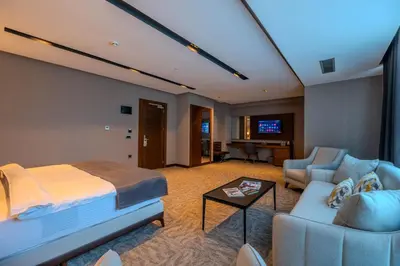 a hotel room with a bed and a living room at B'İSTANBUL HOTEL in Istanbul
