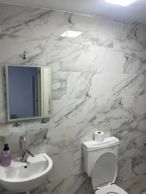 a white bathroom with a sink and a toilet at yeniKAPI hotel in Istanbul