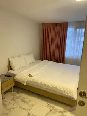 a large bed in a bedroom with a window at hotel YENİkapı in Istanbul