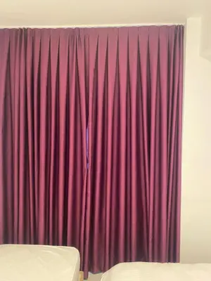 a red curtain in a room with a bed at YENİkapı hotel in Istanbul