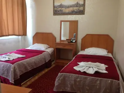 a hotel room with two beds with towels on them at Ekol Hotel in Istanbul