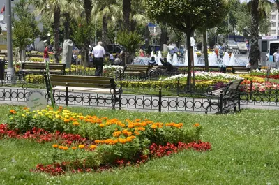 a park with benches and flowers in the grass at Ekol Hotel in Istanbul