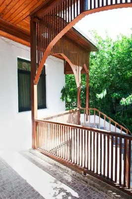 a wooden porch of a house with a wooden roof at Orhan Kutbayin Evi in Buyukada