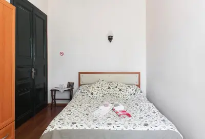 a bedroom with a bed with shoes on it at Orhan Kutbayin Evi in Buyukada