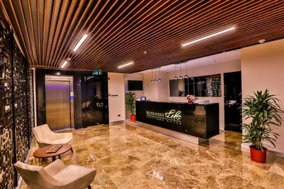 a lobby with chairs and a bar in a building at Business Life Hotel & Spa Şişli in Istanbul