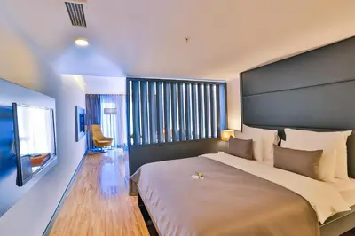 a bedroom with a large bed with a large headboard at Business Life Hotel & Spa Şişli in Istanbul